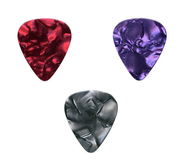 Three guitar picks in red, purple, and black on a white background